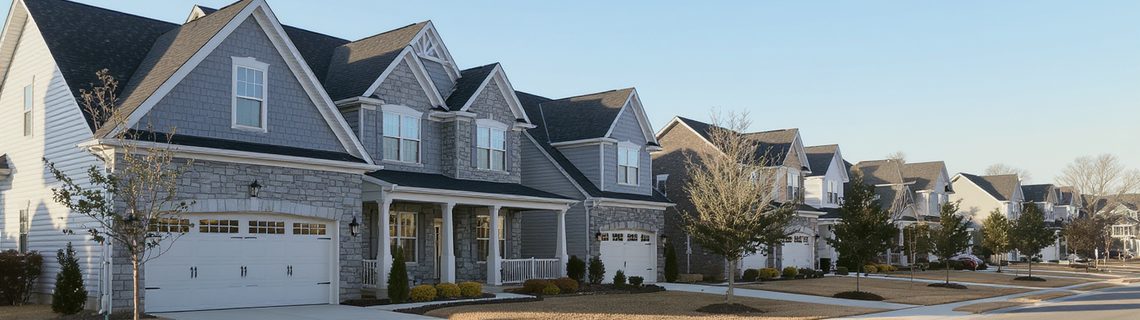 Newer Pennsylvania suburban development of stone-front colonial homes on a curving street