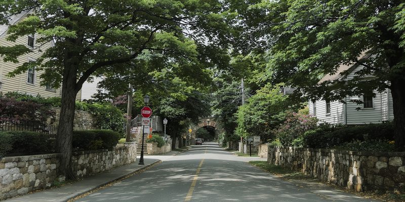 Pennsylvania creekside town with stone and clapboard houses along a tree-shaded road