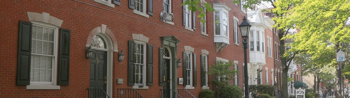 Historic Pennsylvania borough street of brick Federal and Victorian townhouses with iron railings