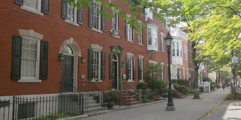 Historic Pennsylvania borough street of brick Federal and Victorian townhouses with iron railings