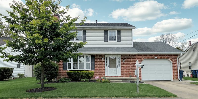 Modest well-kept Pennsylvania suburban starter home with a small front lawn